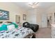 Bright bedroom featuring two twin beds with decorative pillows and ceiling fan at 935 Tidewater Shores # 721, Bradenton, FL 34208