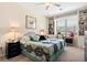 Cozy bedroom with a ceiling fan, a window, and built-in shelves perfect for reading at 935 Tidewater Shores # 721, Bradenton, FL 34208