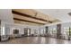 Spacious clubhouse featuring a large seating area, coffered ceilings, wood-look floors, and decorative light fixtures at 935 Tidewater Shores # 721, Bradenton, FL 34208