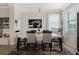 Formal dining room features a modern table, stylish chairs and ample natural light at 935 Tidewater Shores # 721, Bradenton, FL 34208