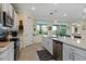 Bright open kitchen with white cabinets, stainless steel appliances and large island at 935 Tidewater Shores # 721, Bradenton, FL 34208