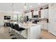 Open kitchen featuring quartz countertops, island with barstool seating and modern lighting at 935 Tidewater Shores # 721, Bradenton, FL 34208