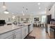 Open concept with spacious kitchen featuring a large center island and adjacent dining area at 935 Tidewater Shores # 721, Bradenton, FL 34208