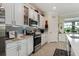 Bright kitchen featuring white cabinets, stainless steel appliances and decorative backsplash at 935 Tidewater Shores # 721, Bradenton, FL 34208