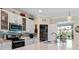 Kitchen features stainless steel appliances, white cabinetry, and a breakfast bar with a stone countertop at 935 Tidewater Shores # 721, Bradenton, FL 34208