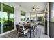 Comfortable lanai with a ceiling fan, outdoor seating, and sliding glass doors at 935 Tidewater Shores # 721, Bradenton, FL 34208