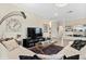 Bright living room features tile floors, a chandelier, and decor that complements the open layout at 935 Tidewater Shores # 721, Bradenton, FL 34208