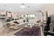 Open living space showing tile floors, modern furniture, and seamless transition to the kitchen area at 935 Tidewater Shores # 721, Bradenton, FL 34208