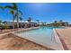Resort-style pool featuring a splash area, covered seating, lounge chairs, and well-manicured tropical landscaping at 935 Tidewater Shores # 721, Bradenton, FL 34208