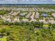 A wide aerial shot of the community showing multiple homes, well-manicured landscaping, and ponds at 9361 Carnaby Dr, Venice, FL 34293