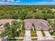 Aerial view of homes with well-maintained lawns, driveways, and mature trees at 9361 Carnaby Dr, Venice, FL 34293