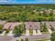 Aerial view of homes with well-maintained lawns, driveways, and mature trees at 9361 Carnaby Dr, Venice, FL 34293