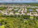 Aerial view of a residential area featuring homes, ponds, and lush greenery, with a home circled at 9361 Carnaby Dr, Venice, FL 34293