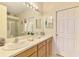 The bathroom boasts double sinks, a large mirror, and a shower with glass door at 9361 Carnaby Dr, Venice, FL 34293