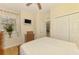Bedroom with wood floors, ceiling fan, and double-door closet at 9361 Carnaby Dr, Venice, FL 34293