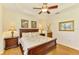 Bright bedroom features a wooden bed, coordinating nightstands, and framed artwork at 9361 Carnaby Dr, Venice, FL 34293