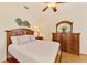Cozy bedroom with wood floors and a matching dresser and nightstand at 9361 Carnaby Dr, Venice, FL 34293