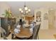 The dining room flows into the kitchen, featuring a chandelier, and view of the modern appliances at 9361 Carnaby Dr, Venice, FL 34293