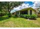 The back exterior of the home showing the well-maintained lawn and landscaping at 9361 Carnaby Dr, Venice, FL 34293
