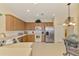 Bright kitchen with stainless steel appliances, wooden cabinets, tile floors and a breakfast nook at 9361 Carnaby Dr, Venice, FL 34293