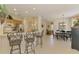 Stylish kitchen with stainless steel appliances, island bar seating, open dining area with modern decor at 9361 Carnaby Dr, Venice, FL 34293