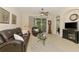 Comfortable living room featuring tile floors, modern furniture, and natural light from the sliding glass door at 9361 Carnaby Dr, Venice, FL 34293