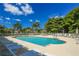Relaxing community pool surrounded by lush landscaping, seating, and palm trees at 9361 Carnaby Dr, Venice, FL 34293