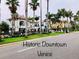 Street view of Historic Downtown Venice featuring businesses, palm trees, and a sidewalk at 9361 Carnaby Dr, Venice, FL 34293