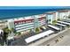 Aerial view of a condo building, parking, and beach at 950 Tarpon Center Dr # 305, Venice, FL 34285