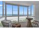 Balcony with seating and an ocean view through floor to ceiling windows at 950 Tarpon Center Dr # 305, Venice, FL 34285