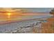 A sunset view of the beach with calm gulf waters at 950 Tarpon Center Dr # 305, Venice, FL 34285