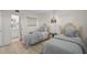 This bedroom features 2 twin beds with stylish decor and a peek into the ensuite bathroom at 950 Tarpon Center Dr # 305, Venice, FL 34285