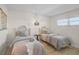Cozy bedroom with twin beds, coastal decor, and a relaxing ambiance at 950 Tarpon Center Dr # 305, Venice, FL 34285