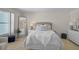 Bright bedroom with a full bed, wicker headboard, dresser and decorative pillows at 950 Tarpon Center Dr # 305, Venice, FL 34285