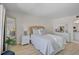 Bright bedroom with a full bed, wicker headboard, dresser, and decor at 950 Tarpon Center Dr # 305, Venice, FL 34285