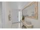 Bright entryway featuring neutral tones, a decorative mirror, and tiled flooring, creating a welcoming ambiance at 950 Tarpon Center Dr # 305, Venice, FL 34285