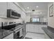 Well-appointed kitchen featuring stainless steel appliances, granite counters, and a view of the ocean at 950 Tarpon Center Dr # 305, Venice, FL 34285