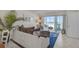 Comfortable living room featuring stylish decor and sliding doors leading to a balcony with ocean views at 950 Tarpon Center Dr # 305, Venice, FL 34285