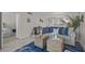 Open-concept living room with ocean views, stylish furnishings, and seamless flow to adjacent rooms at 950 Tarpon Center Dr # 305, Venice, FL 34285