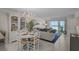 Inviting living room with stylish furniture, opening to a balcony with ocean views at 950 Tarpon Center Dr # 305, Venice, FL 34285