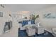 Bright living room with blue accents, stylish furniture, and open access to the kitchen and dining areas at 950 Tarpon Center Dr # 305, Venice, FL 34285