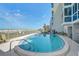 Sparkling community pool offers a refreshing escape with ocean views and comfortable lounge area at 950 Tarpon Center Dr # 305, Venice, FL 34285