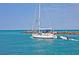Sailboat navigates the clear waters near a rocky breakwater with people at 950 Tarpon Center Dr # 305, Venice, FL 34285