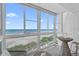 Bright sunroom showcasing breathtaking ocean views through expansive windows at 950 Tarpon Center Dr # 305, Venice, FL 34285