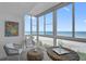 Bright sunroom with wicker furniture, beautiful ocean views, and stylish coastal decor at 950 Tarpon Center Dr # 305, Venice, FL 34285
