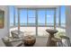 Bright sunroom features wicker furniture and panoramic ocean views, perfect for relaxing at 950 Tarpon Center Dr # 305, Venice, FL 34285