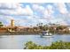 Picturesque waterfront view with a sailboat gliding on the water near a charming town at 950 Tarpon Center Dr # 305, Venice, FL 34285