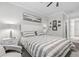 Comfortable bedroom featuring a well-lit space with stylish decor at 121 Colebrook Ct, Venice, FL 34292