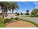 Attractive community entrance sign surrounded by manicured landscaping with a view of the community pond and fountain at 121 Colebrook Ct, Venice, FL 34292
