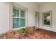 Inviting entryway featuring brick flooring, decorative chairs, and large windows with plantation shutters at 121 Colebrook Ct, Venice, FL 34292